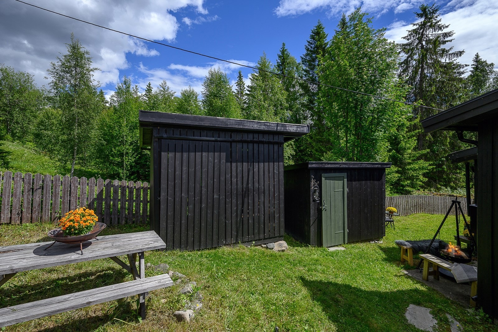 På eiendommen er det flere praktiske uthus for lagring, inkludert vedskjul fra 2021. Galleribilde