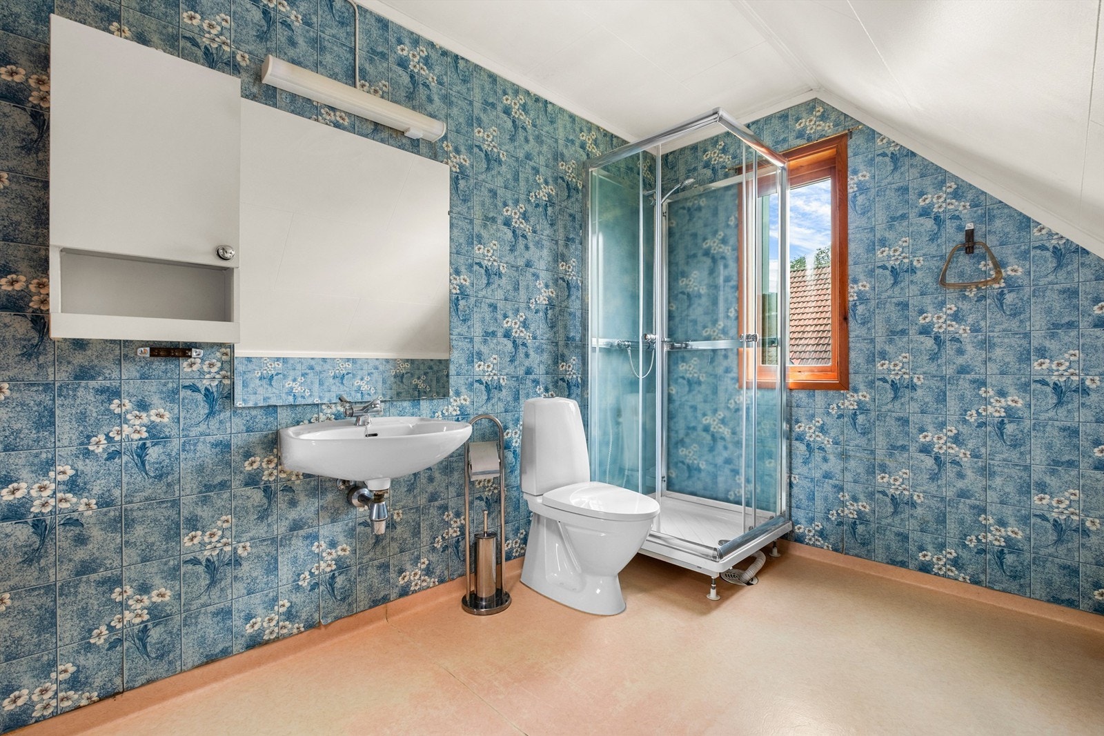 Badet er fra byggeår og er innredet med dusjkabinett, toalett og servant. Galleribilde