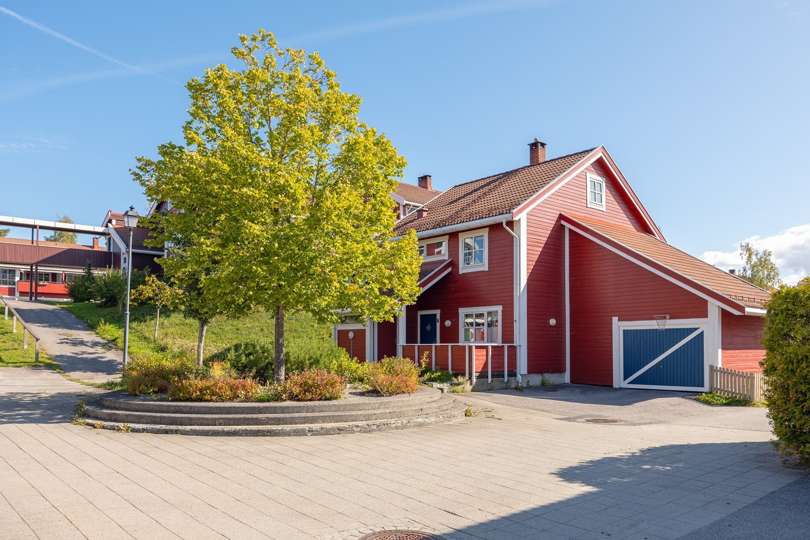 Fellestomten er pent opparbeidet med plenarealer og asfalterte internveier. Galleribilde