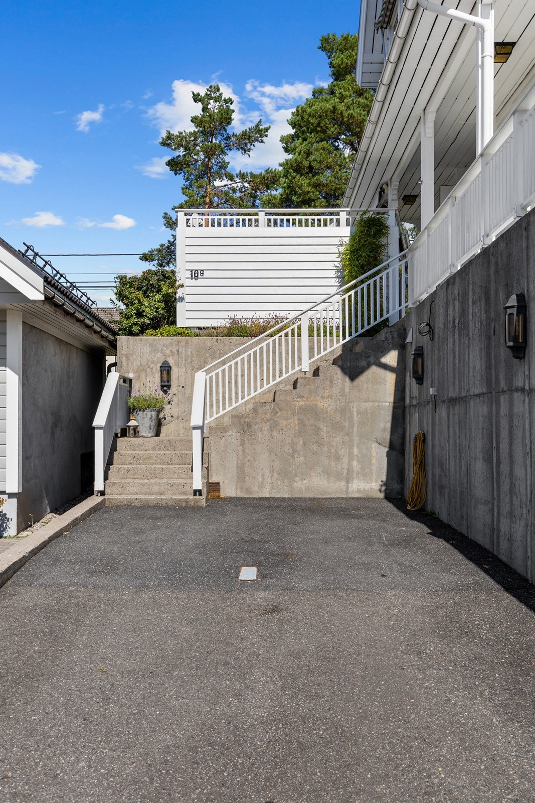 Biloppstillingsplasser foran boligen. Her er det støpt murer, så om det er ønskelig med tak eller carport er det mange muligheter for dette. Galleribilde