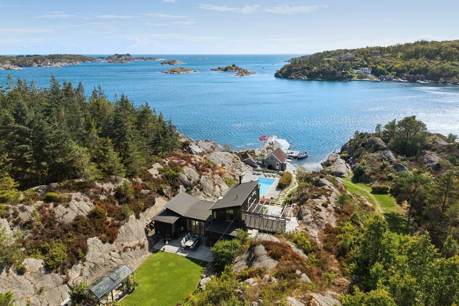 Velkommen til visning av Kystveien 588! Fantastisk beliggende eiendom med utsikt til havet og helt usjenert tomt. Innholdsrik, moderne hytte og sjøbu med stort bryggeanlegg, samt oppvarmet basseng. Galleribilde