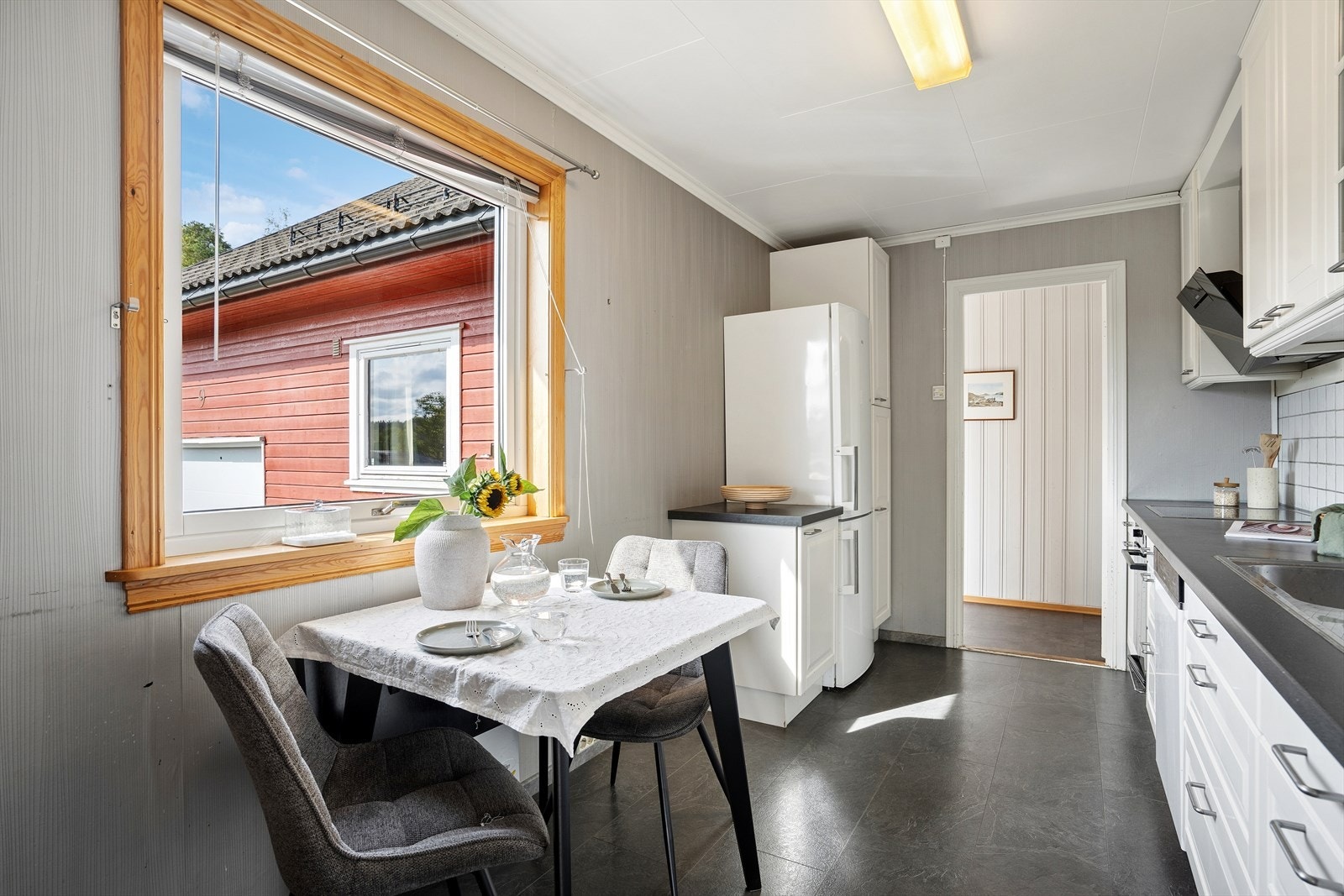 Kjøkkenet har en hyggelig spiseplass ved vinduet. Galleribilde