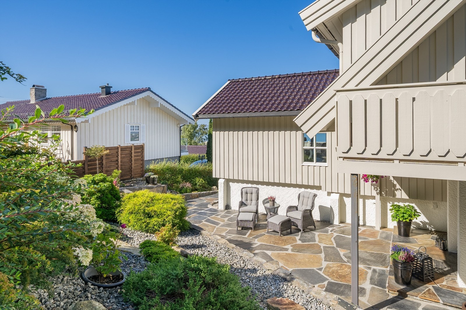 Eiendommen er pent opparbeidet med plattinger, steinbelagte uteområder, bed, plen og asfaltert innkjørsel. Galleribilde