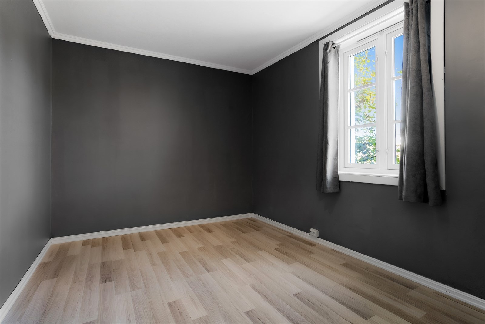 Laminatgulvet fortsetter inn på soverommet for et helhetlig inntrykk. Galleribilde
