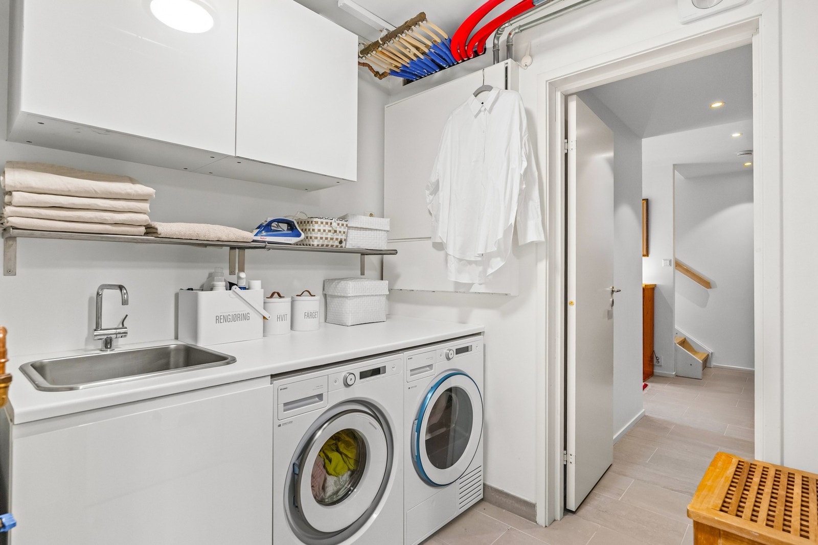 Eget vaskerom/teknisk rom. Innredning med benkeplate fra Ikea med utslagsvask og blandebatteri fra Vola, opplegg for vaskemaskin og tørketrommel. Elektrisk avtrekksvifte. Galleribilde