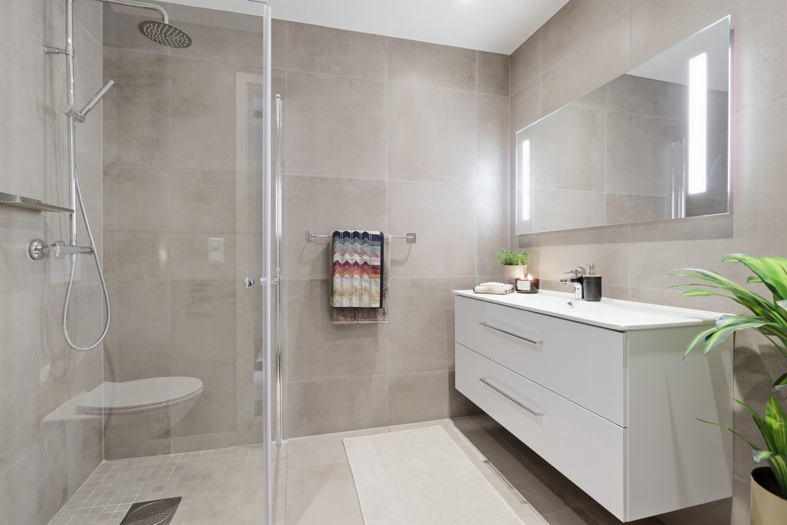 Badet i første etasje gir deg en følelse av moderne komfort med flislagte gulv og vegger i moderne farger. Galleribilde