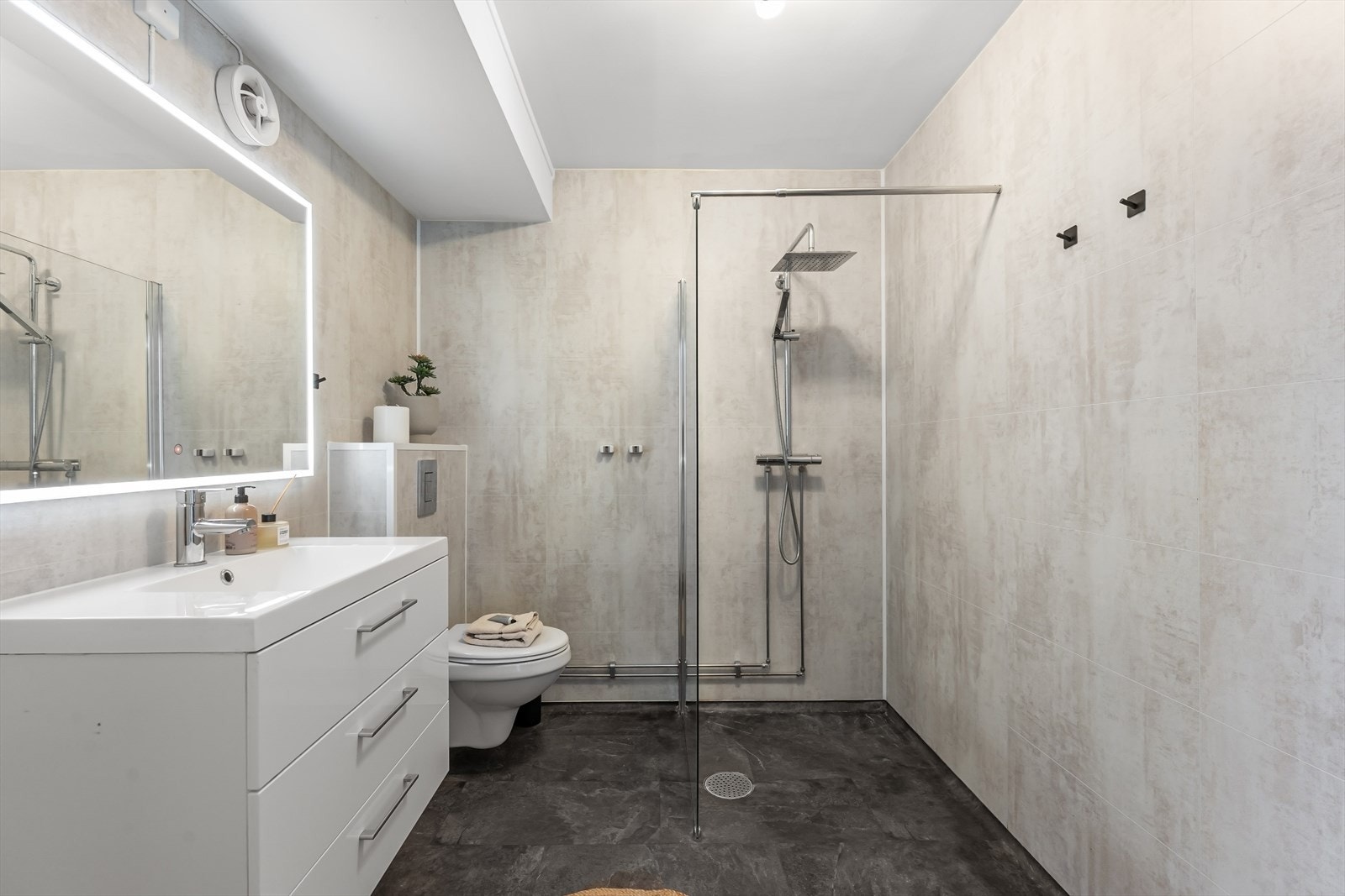 Badet har belegg på gulv, våtromsplater på vegger og malt overflate i himlingen. Galleribilde