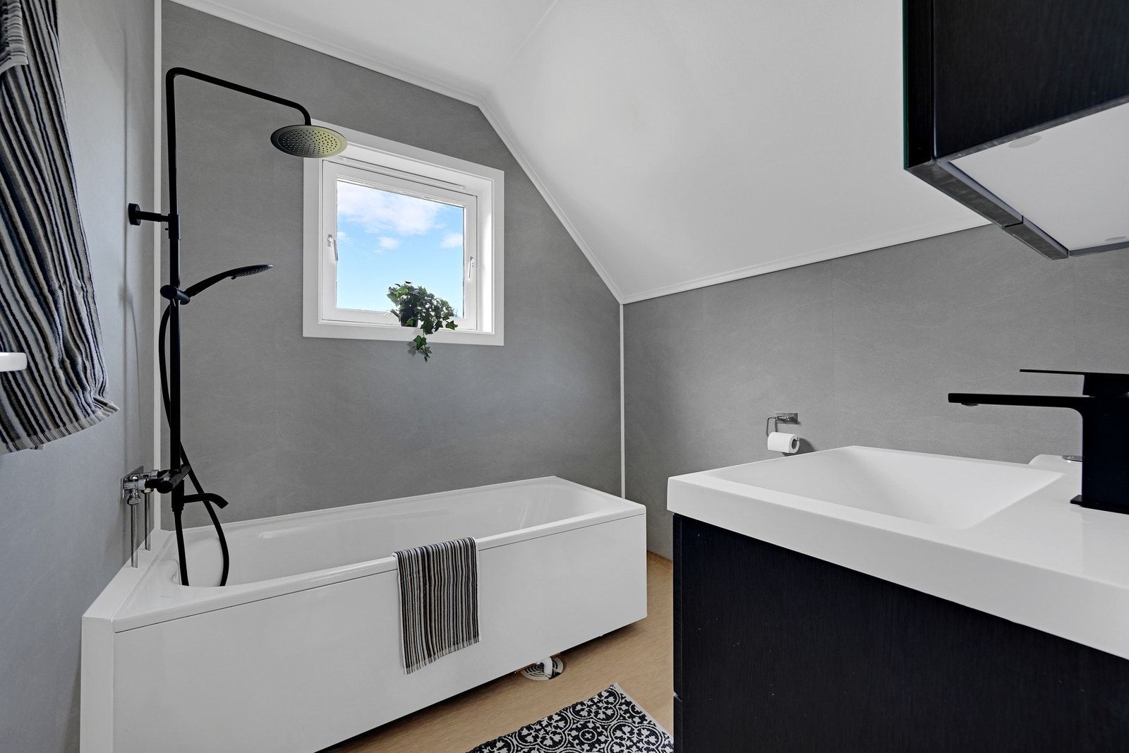 Delikat bad med badekar og moderne, sort dusjløsning. Galleribilde