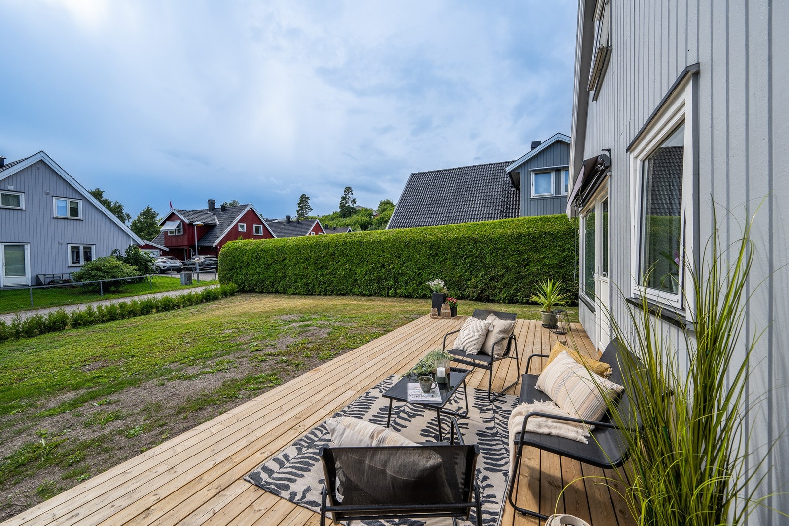 Herlig terrasse med direkte tilknytning til hagen - en lun og hyggelig uteplass med god plass til sittegruppe Galleribilde