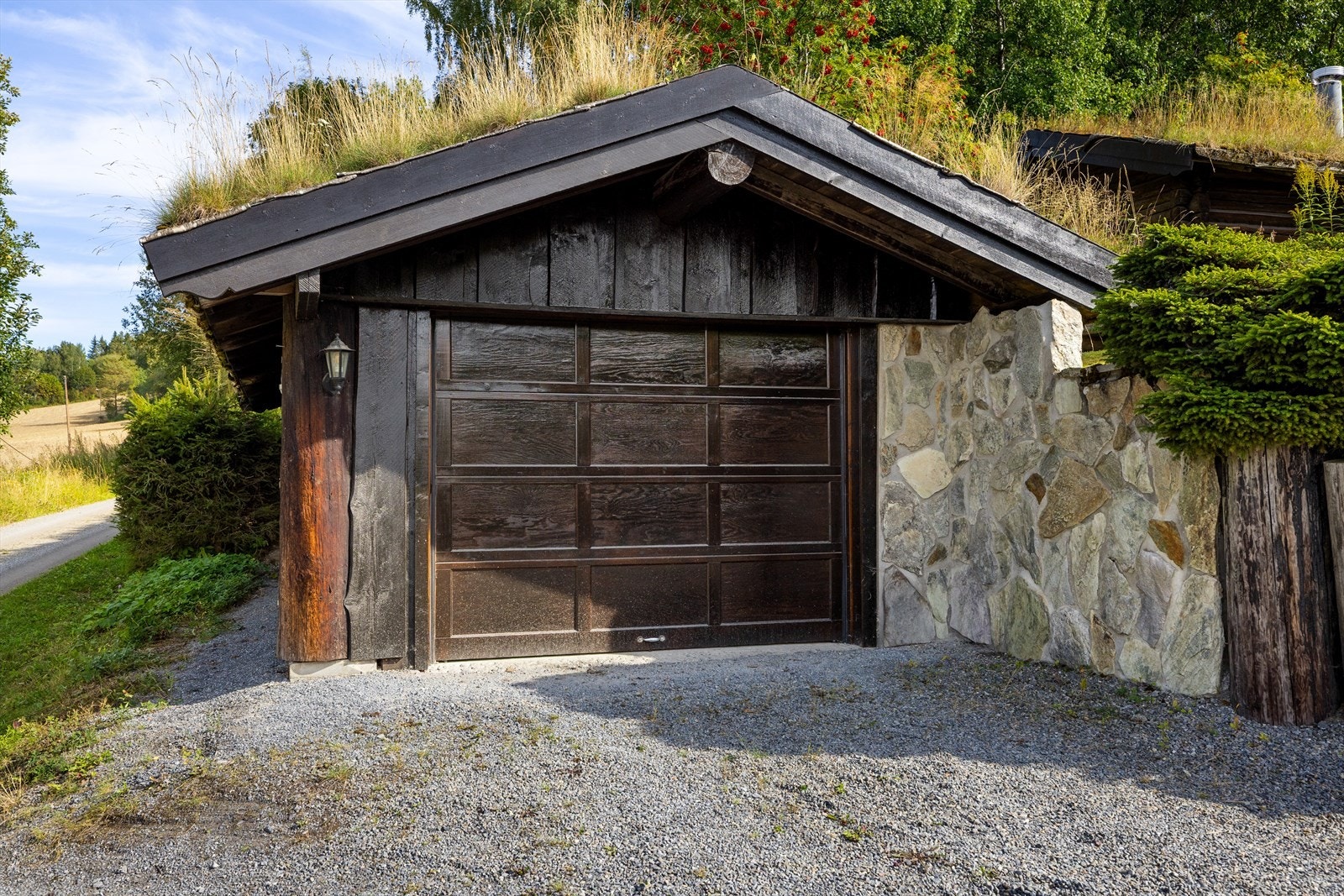Garasje som er fint integrert på tomta og står i stil til resten av bebyggelsen. Galleribilde