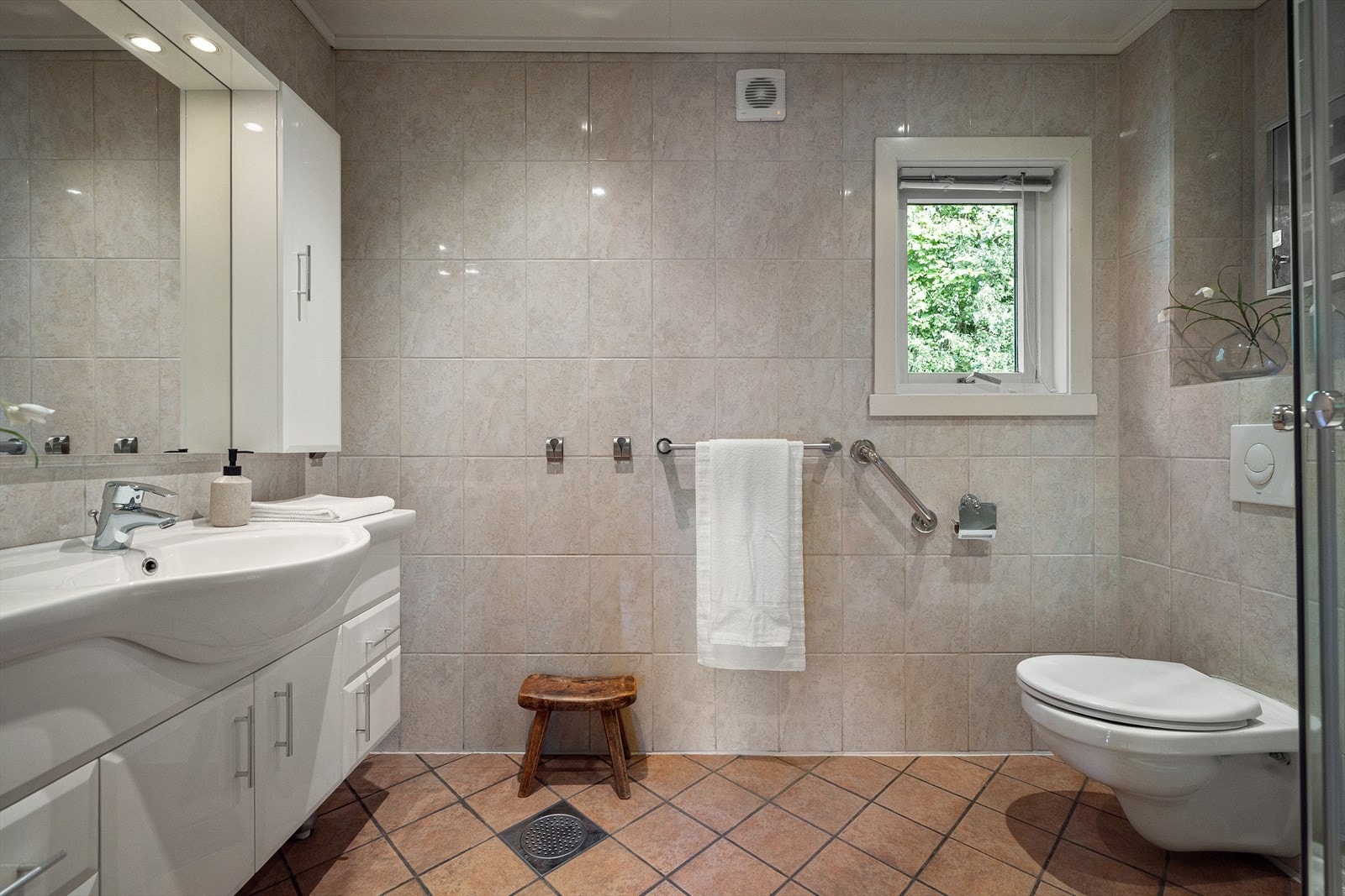 Badet er utstyrt med elektrisk gulvvarme og fliser på gulv og vegger, og gir et solid utgangspunkt for videre modernisering og personlig tilpasning. Galleribilde