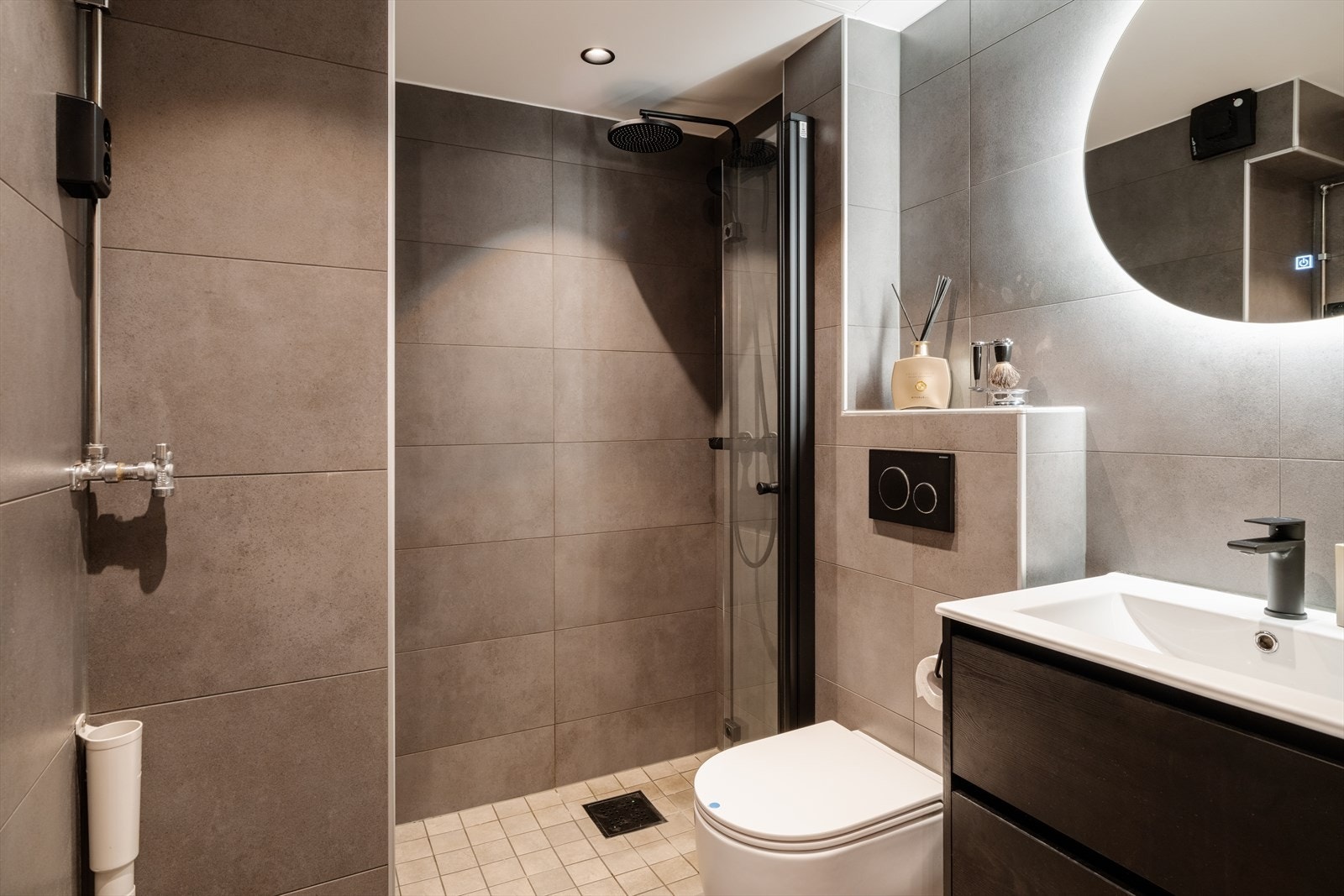 Badet ble oppgradert i 2024 med fliser, elektrisk gulvvarme og regndusj. Galleribilde