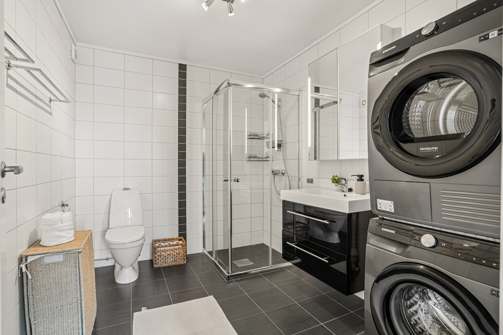 Badet er moderne og innbydende, med fliser på vegg og gulv, samt elektriske varmekabler for ekstra komfort. Galleribilde
