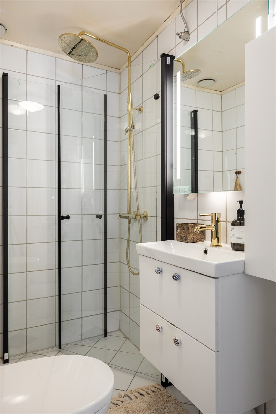 Badet er innredet med lyse fliser på veggene og malt himling Galleribilde