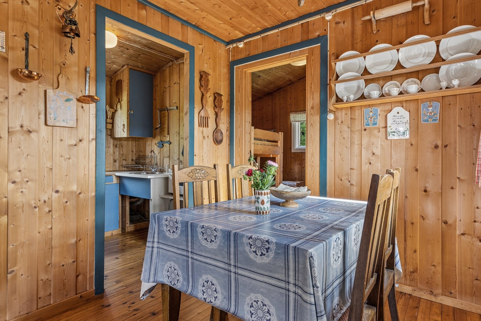Spisestuen har tregulv og panelte vegger, med videre adkomst til soverommet. Galleribilde