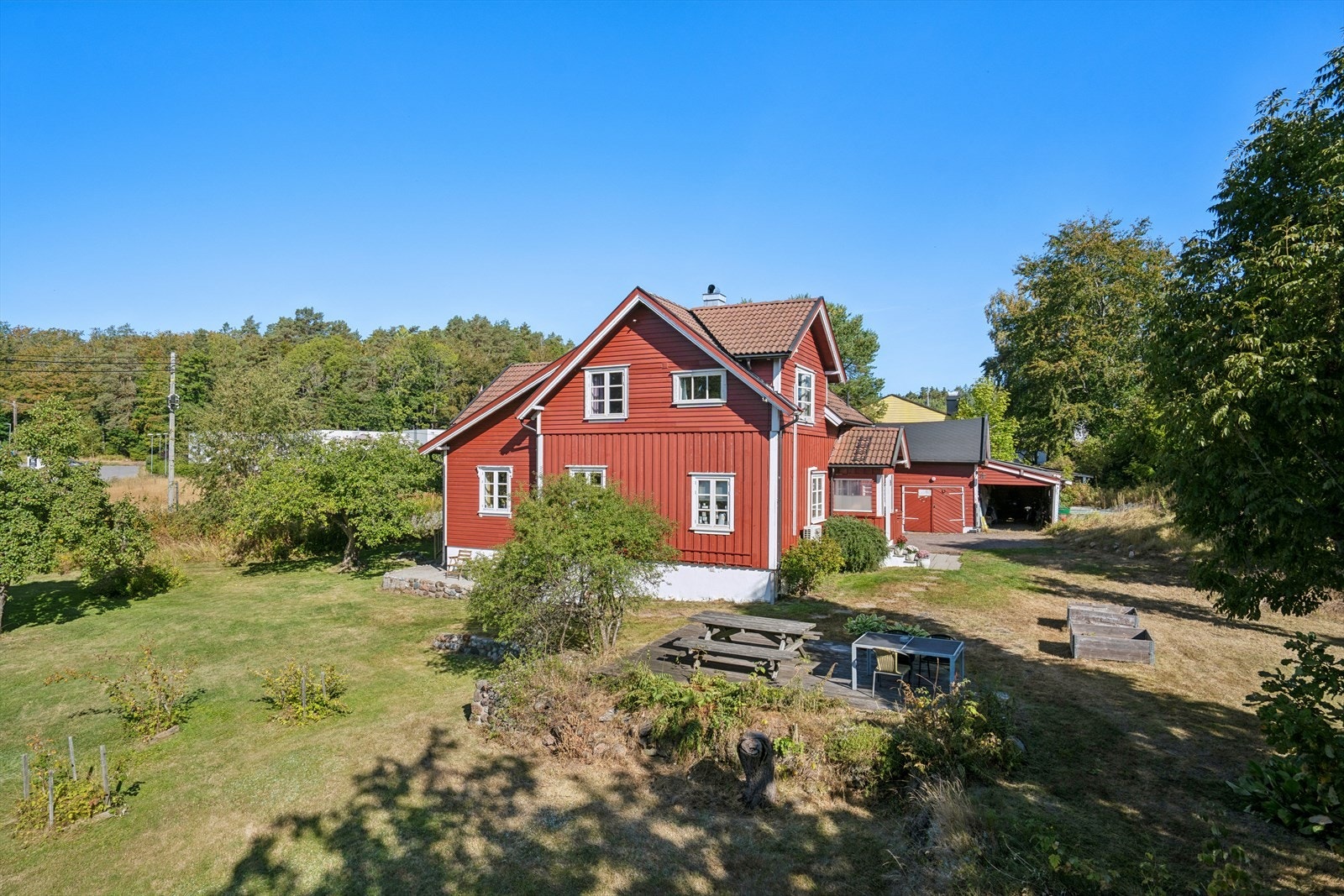 Frittstående terrasseplatting på terreng med plass til sittegruppe i hagen. Galleribilde