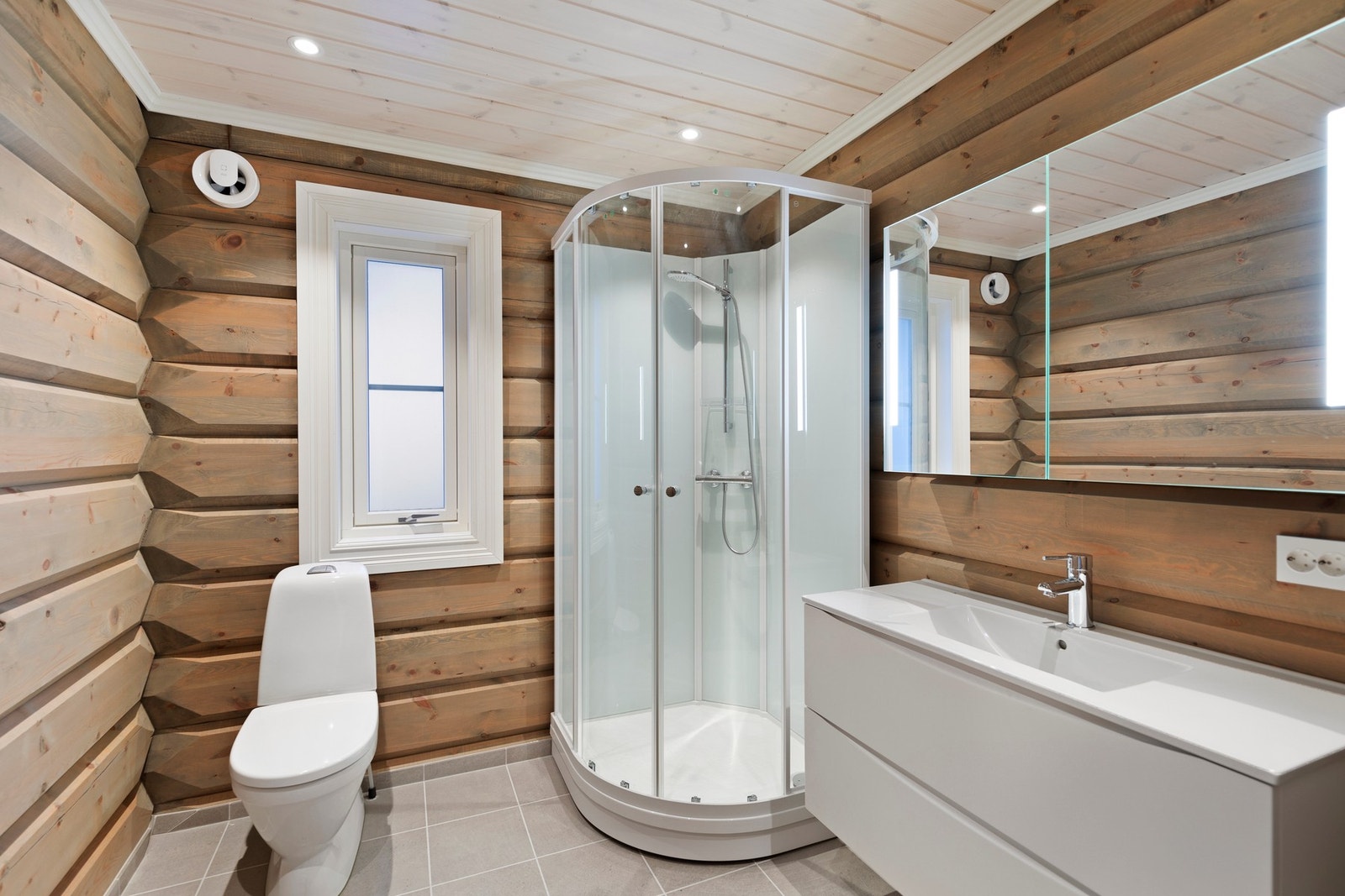 Badet i hovedetasjen er utstyrt med gulvvarme, downlights, toalett, baderomsinnredning og dusjkabinett Galleribilde