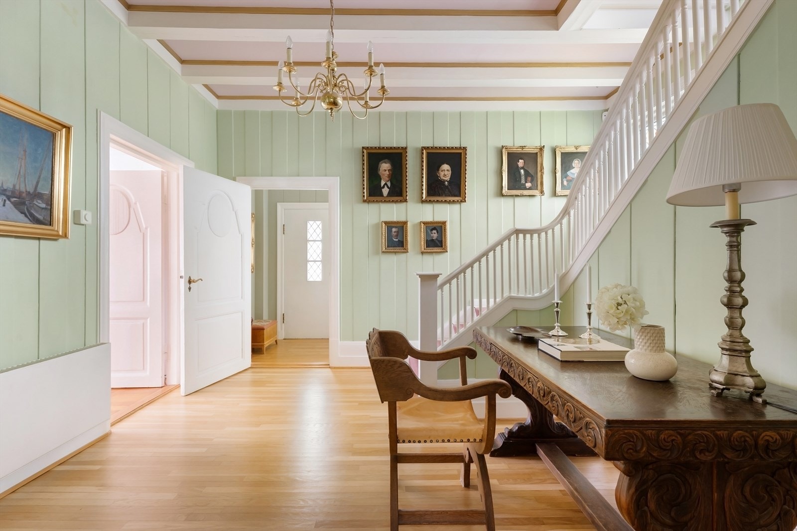 Den representative hallen ønsker velkommen med originalt panel og trapp til andre etasje. Galleribilde