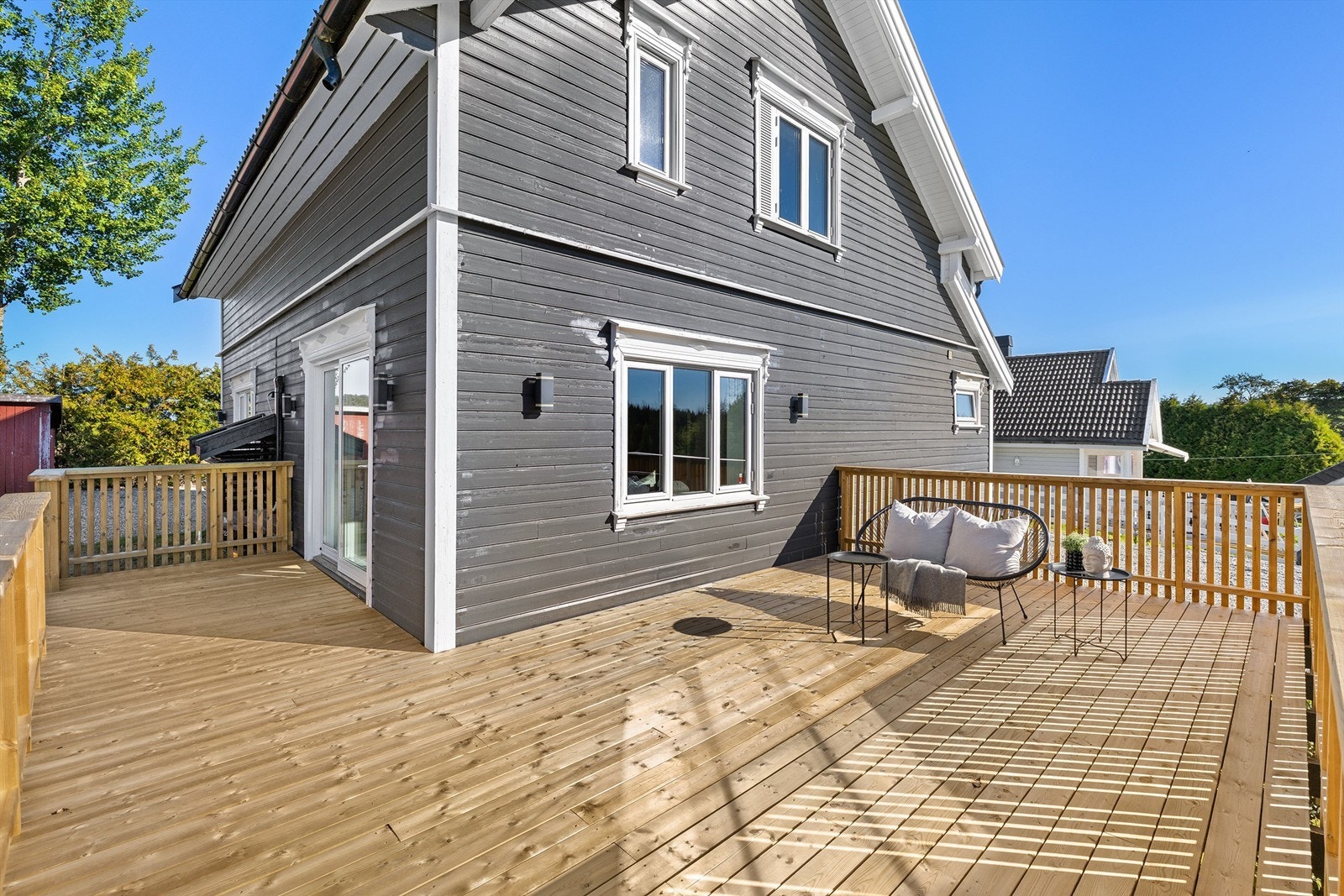 Romslig terrasse i trekonstruksjoner med god plass til sittegruppe. Galleribilde
