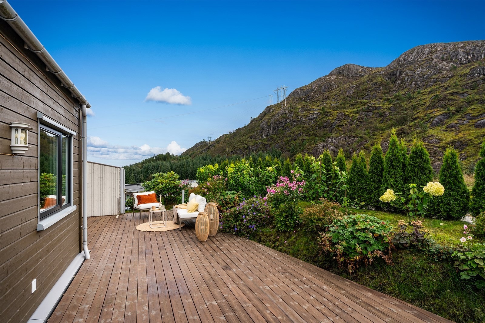 - Selger har plantet en rekke vakre hortensia foran hekken samt flere Rhododendron, og andre stauder og grønne planter - (Merk at deler av terrassen ligger utenfor tomtegrensene) Galleribilde
