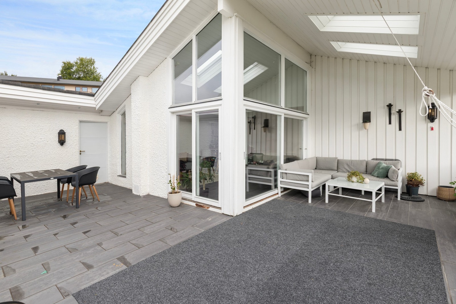 Terrassen har flis på gulv, er delvis overbygget og har nydelig utsikt mot blant annet Sykkylvsfjorden og omkringliggende fjell. Galleribilde