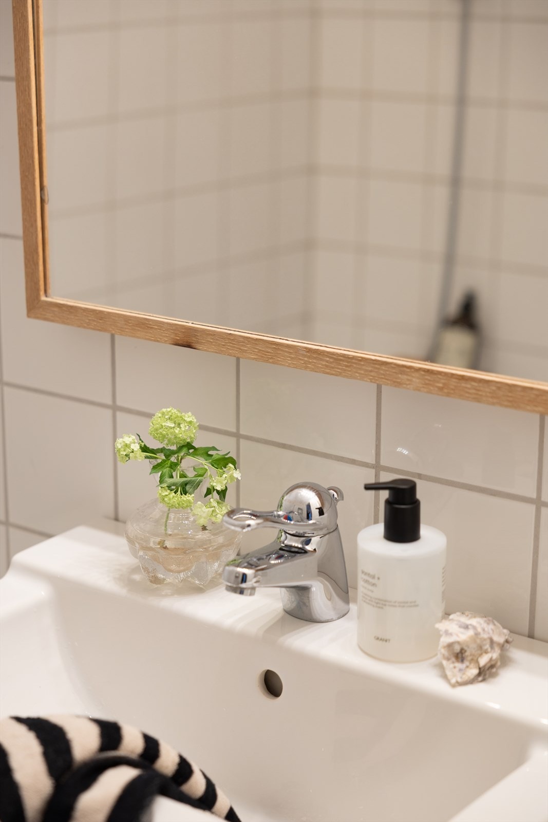 Baderommet er utstyrt med innfliset badekar, servant med innredning, gulvstående klosett, veggskap og speil over servant Galleribilde