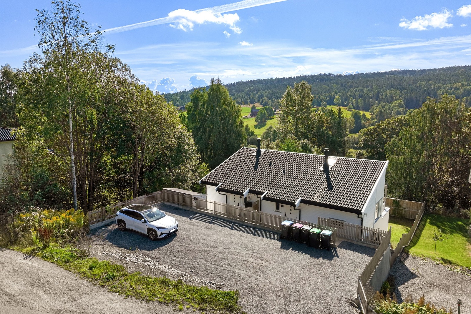 Eiendommen har gode parkeringsmuligheter på egen gårdsplass og ligger fint til i grønne, landlige omgivelser. Galleribilde