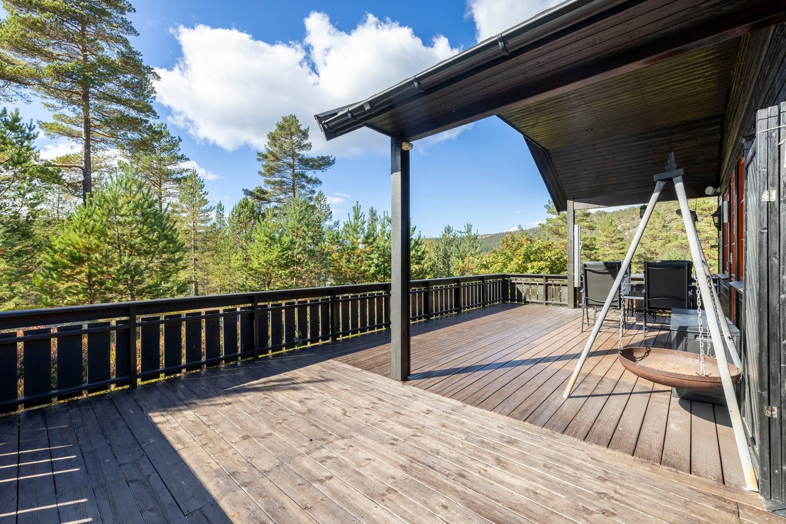 Overbygget terrasse gir en lun og skjermet uteplass, perfekt for å nyte utsikten året rundt. Galleribilde