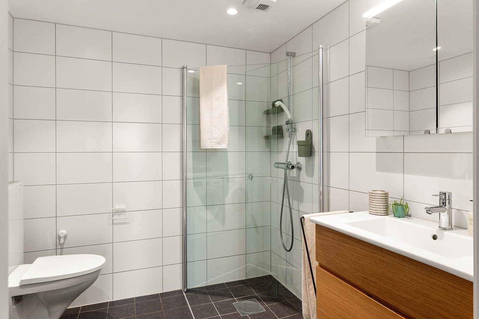 Innbydende og delikat flislagt baderom av god størrelse med tidløse flisvalg og downlights (led) i himling. Baderommet er av nyere standard fra byggeåret (2019). Galleribilde