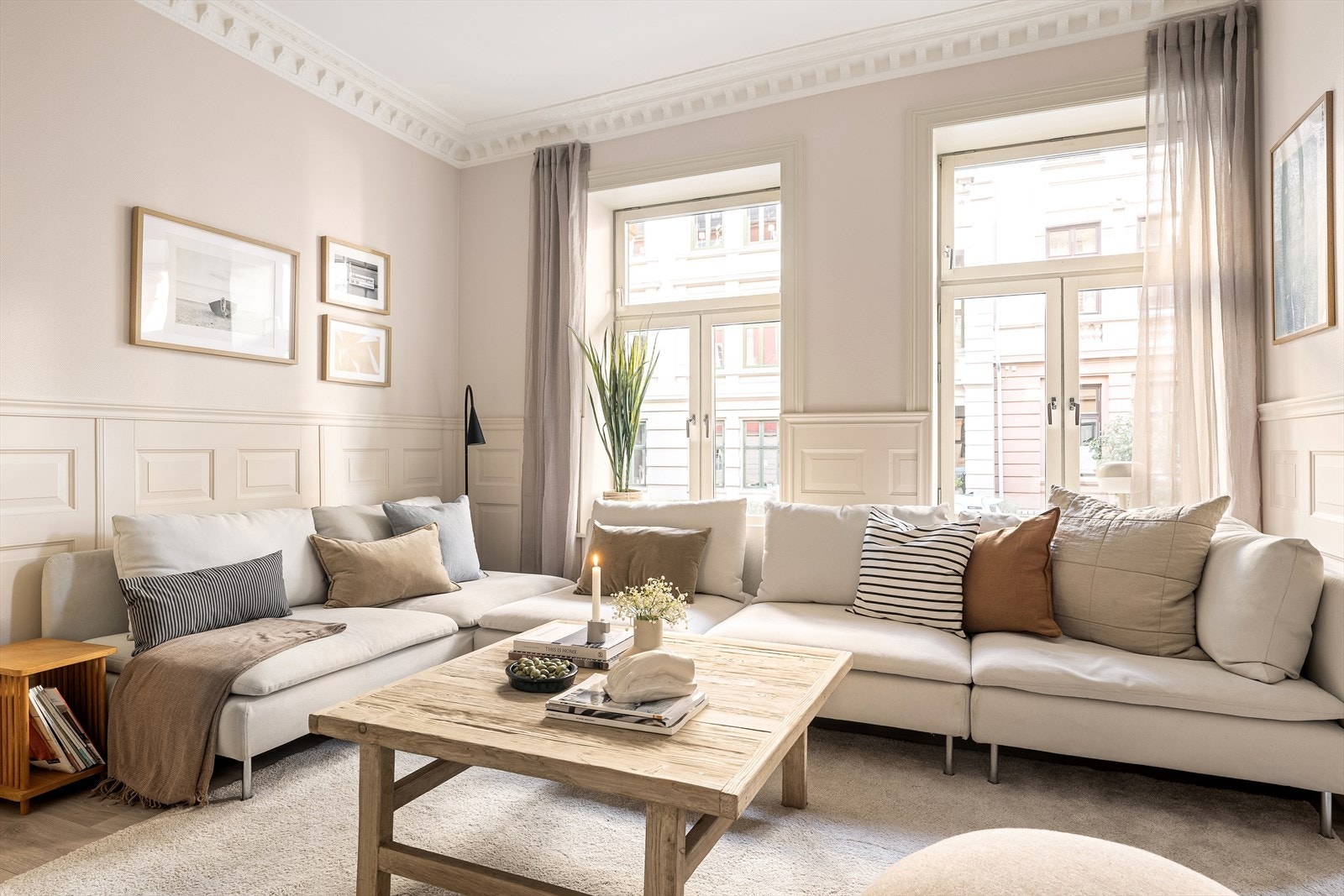 Lys og romslig stue med dekorativ veggbrystning, stukkatur og rosetter i de fleste rom. Galleribilde