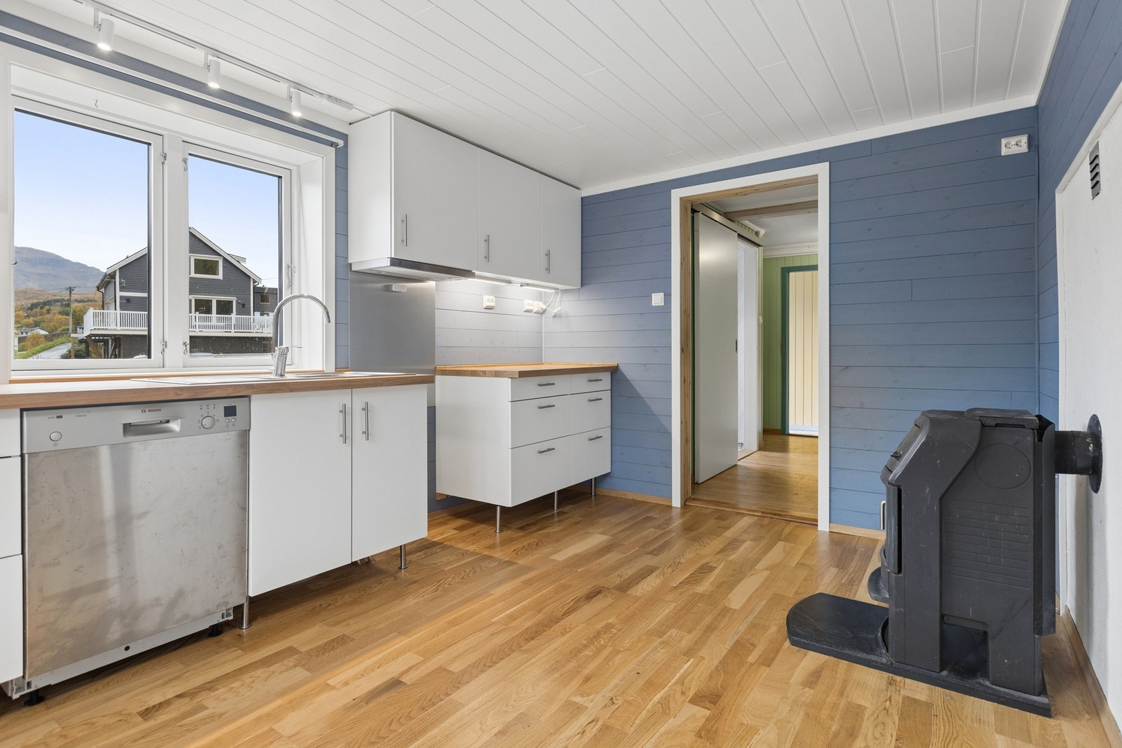 Kjøkkenet er utstyrt med vedovn og har plass til spisebord ved vinduet. Galleribilde
