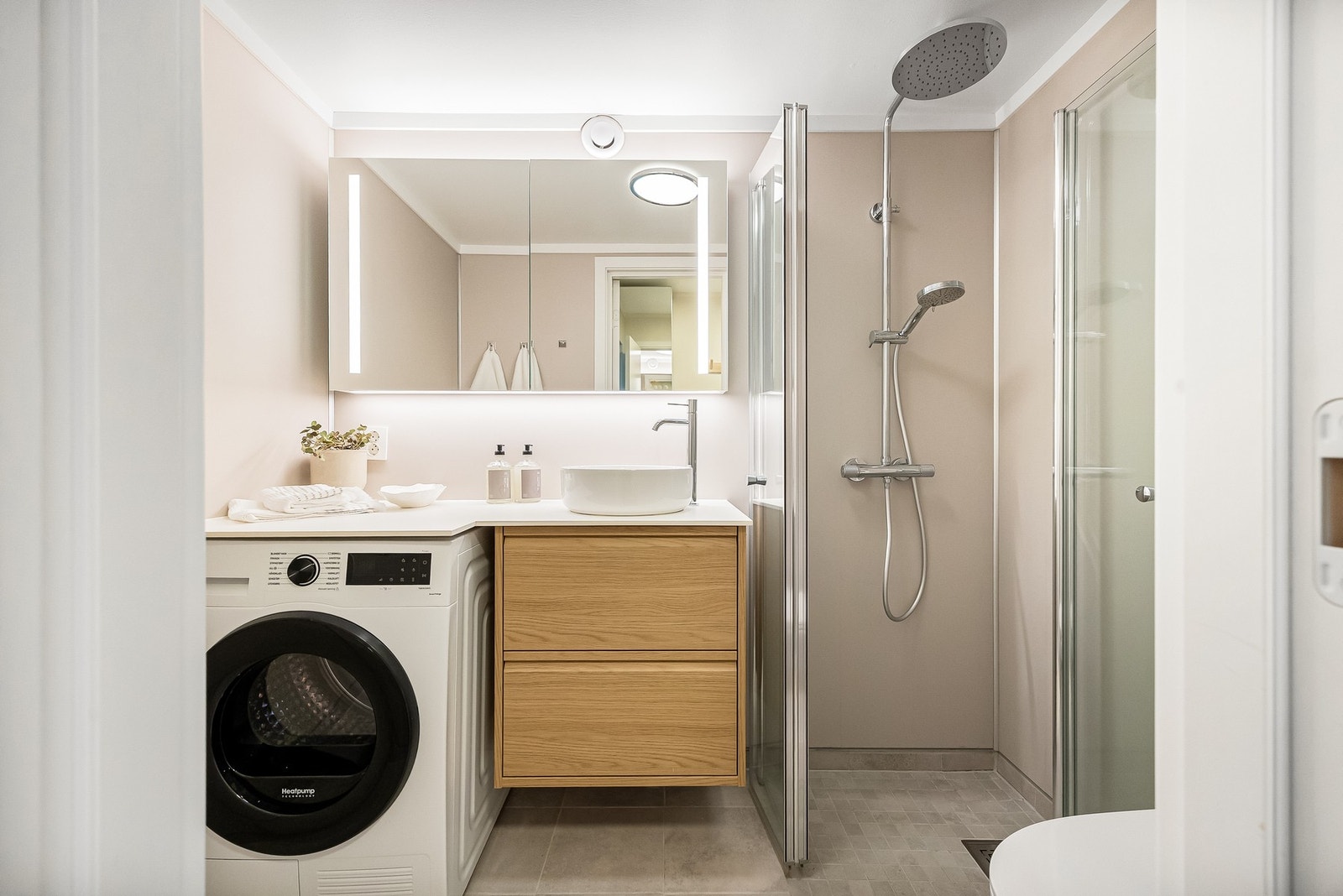 Badet har en arealeffektiv og funksjonell løsning med flislagt gulv, og gir et moderne inntrykk. Galleribilde