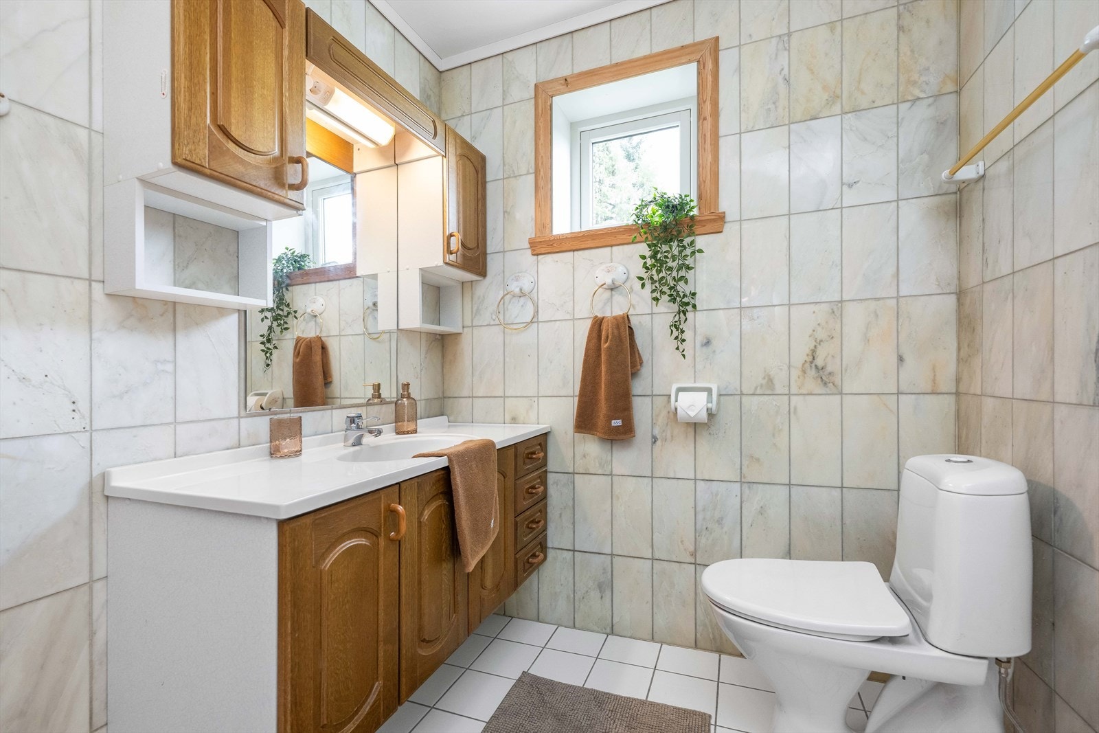 Badet inneholder toalett, dusjkabinett, og servant med møblement. Galleribilde