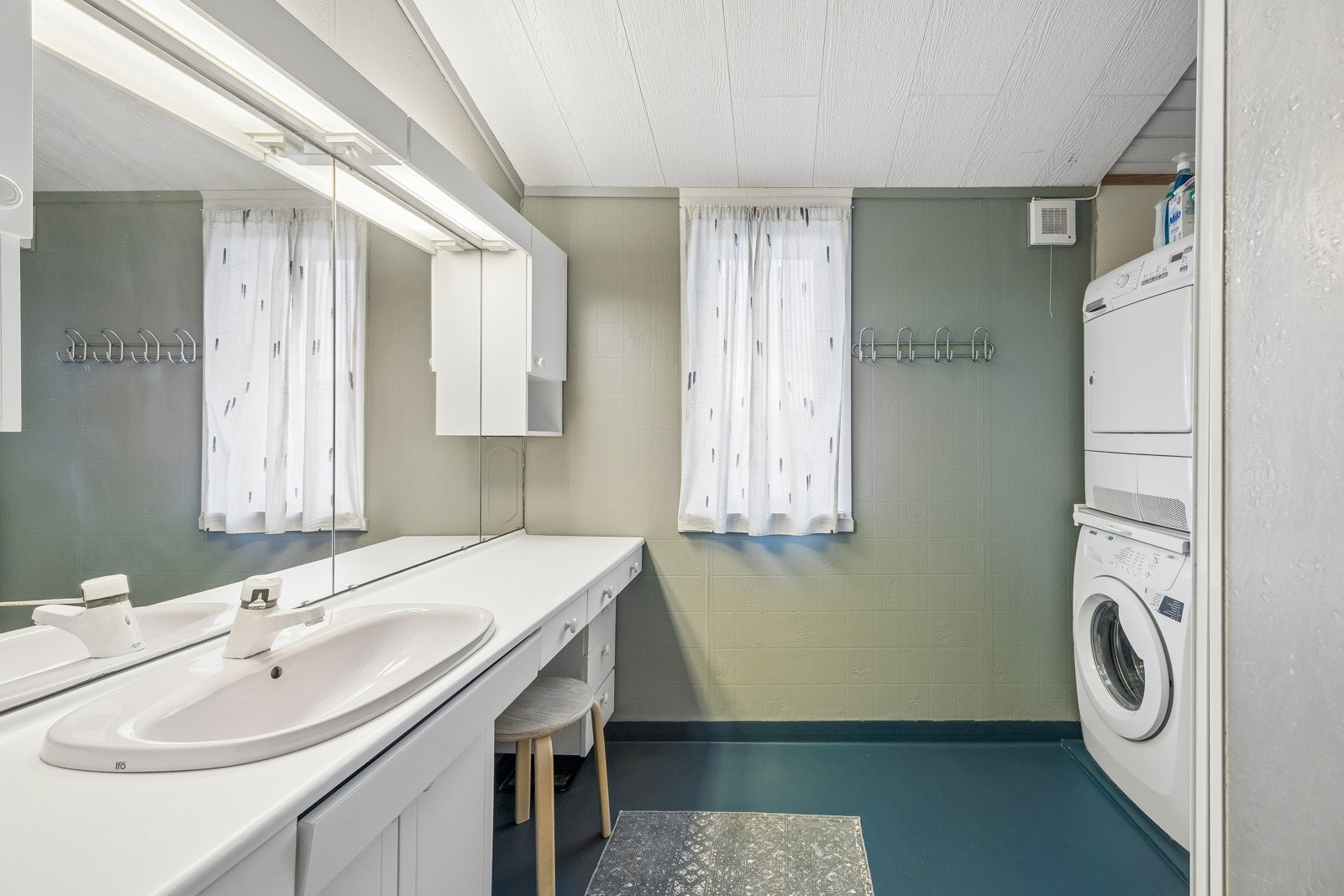 Bad/vaskerom i hovedetasje med dusj, baderomsinnredning og opplegg for vaskemaskin