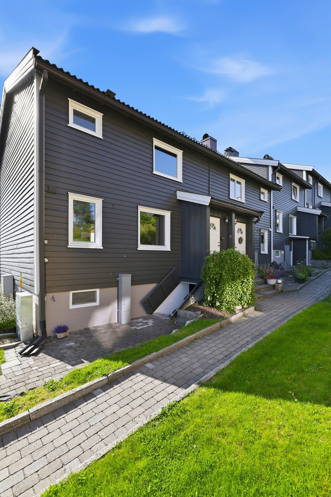 Gangvei langs siden av huset leder til inngangspartiet. Her er det felles kjellernedgang utenfra for 76A og 76B. Galleribilde