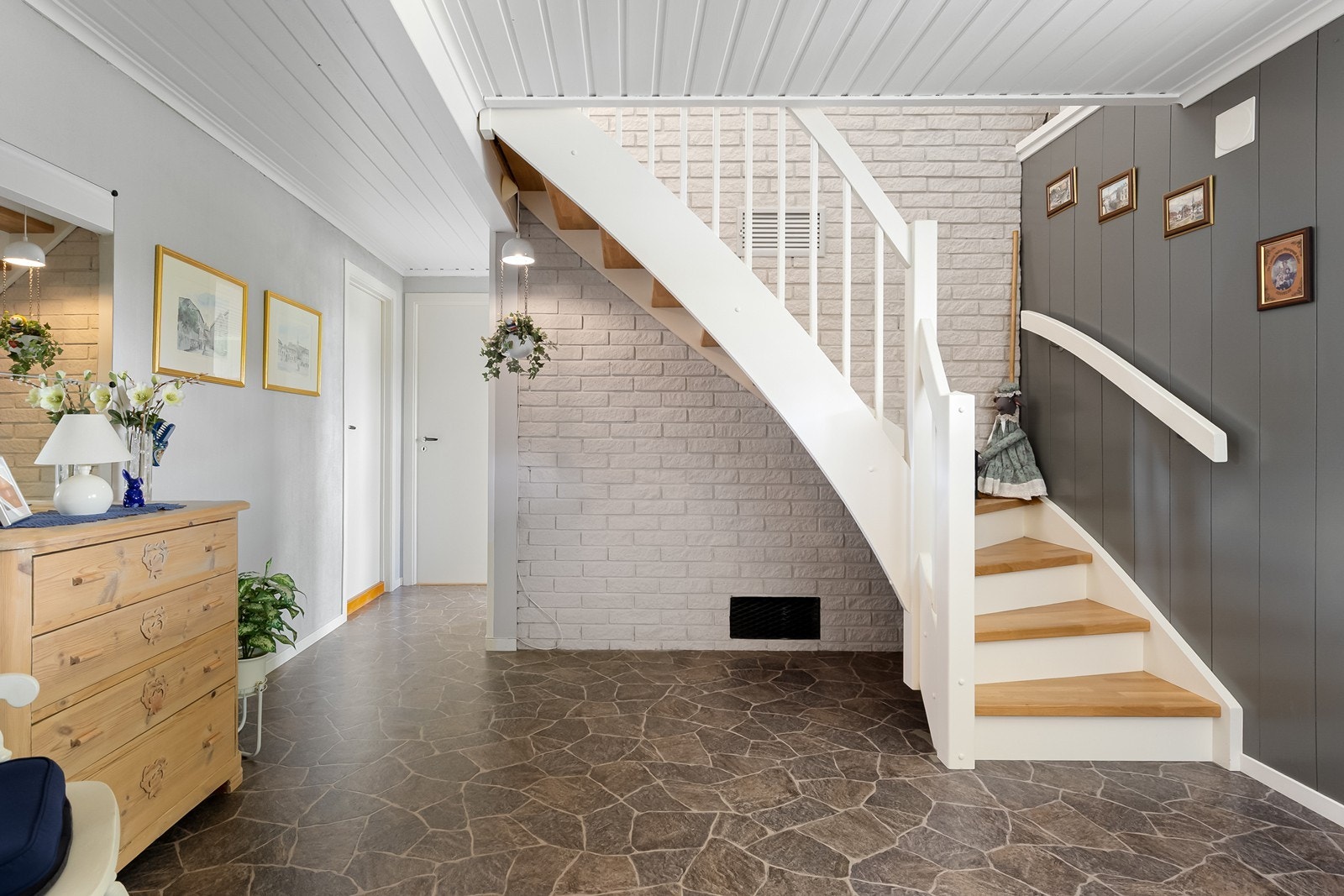 Romslig og hyggelig hall med trappeforbindelse mellom etasjene. Galleribilde