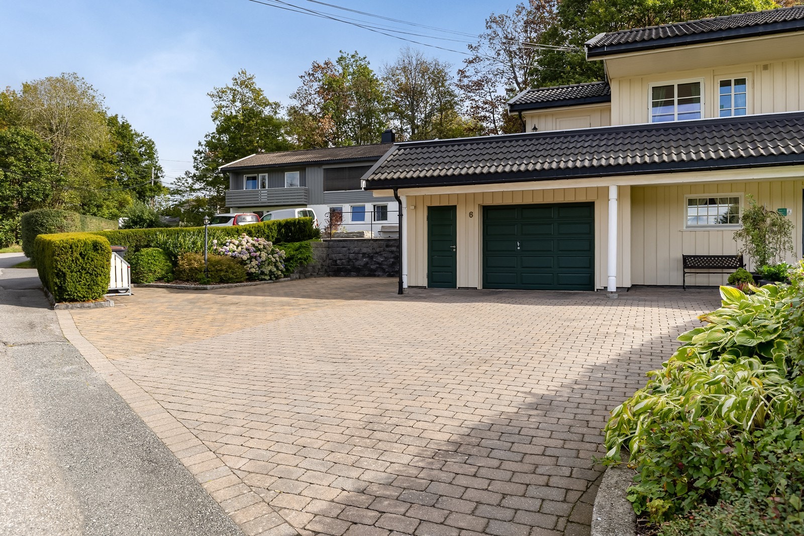 Pent opparbeidet gårdsplass med garasje og gode parkeringsmuligheter for flere biler. Galleribilde