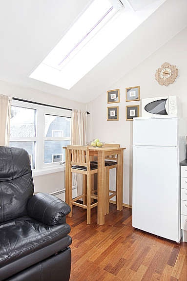 En praktisk møblering gjør at man også får plass til et bord med tilhørende barkrakker. Galleribilde