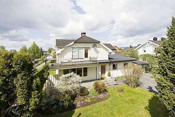 Fasade fra forsiden med deler av hagen Galleribilde