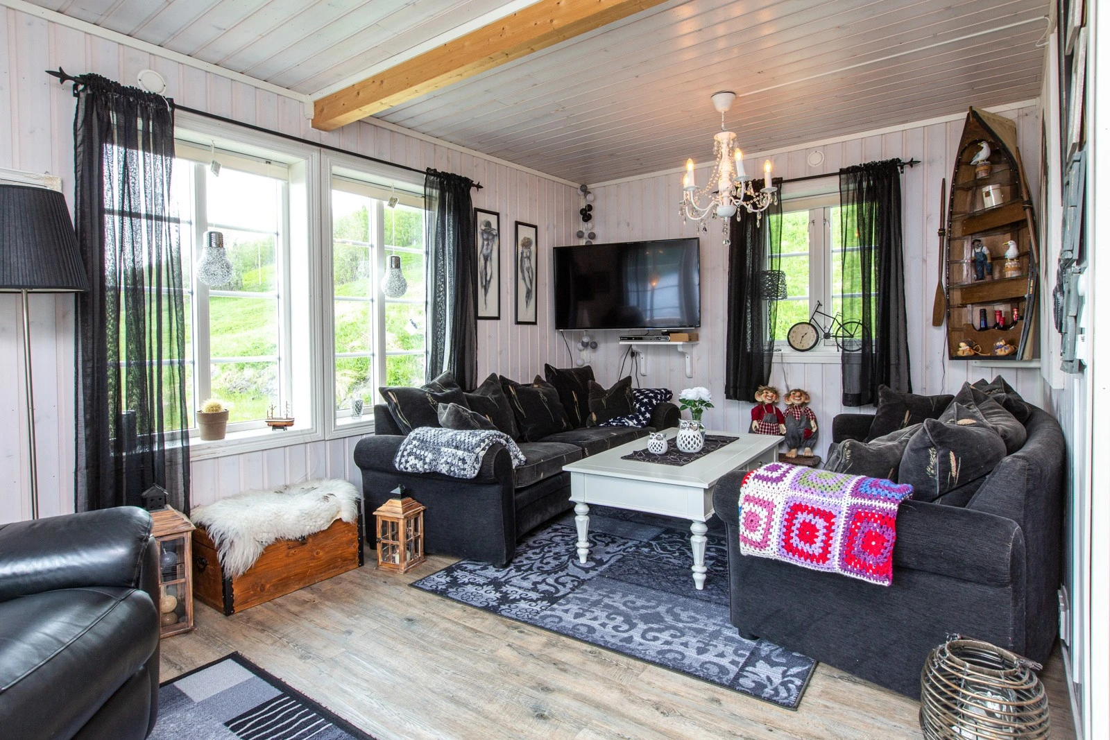 Koselig stue med flere vinduer som gir godt med lys Galleribilde