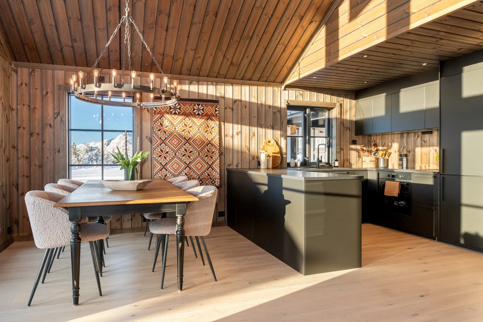 Det er åpen løsning mellom kjøkken og stue som gir både en praktisk løsning og en sosial sone i oppholdsrommet. Galleribilde