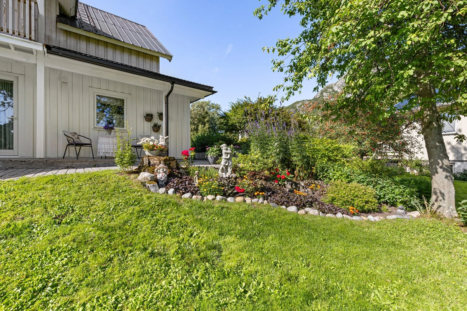 Hagen er velstelt med store plenareal, trær, busker og vakre blomsterbed. Galleribilde