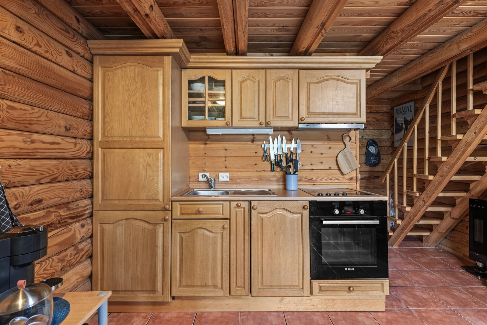 Kjøkkenet er innredet med platetopp, komfyr, kjøl/frys og oppvaskmaskin Galleribilde