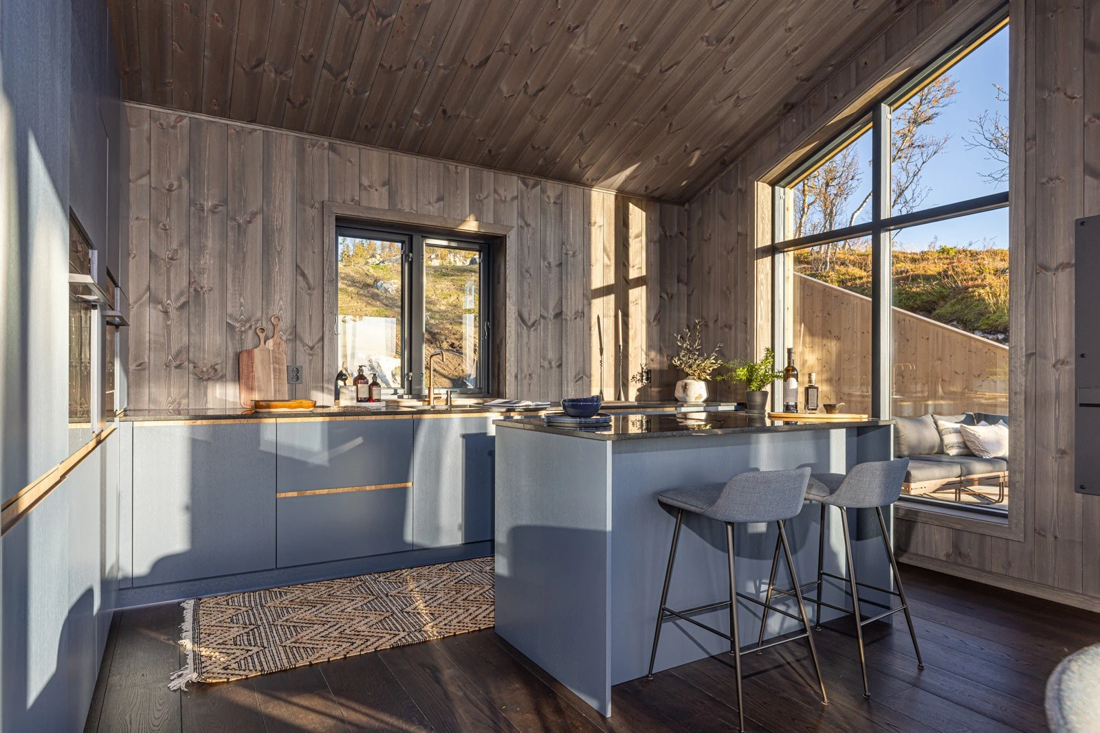 Moderne kjøkken fra MBA Møbler med slette fronter og eikedetaljer, granitt benkeplate og armatur i kobber Galleribilde