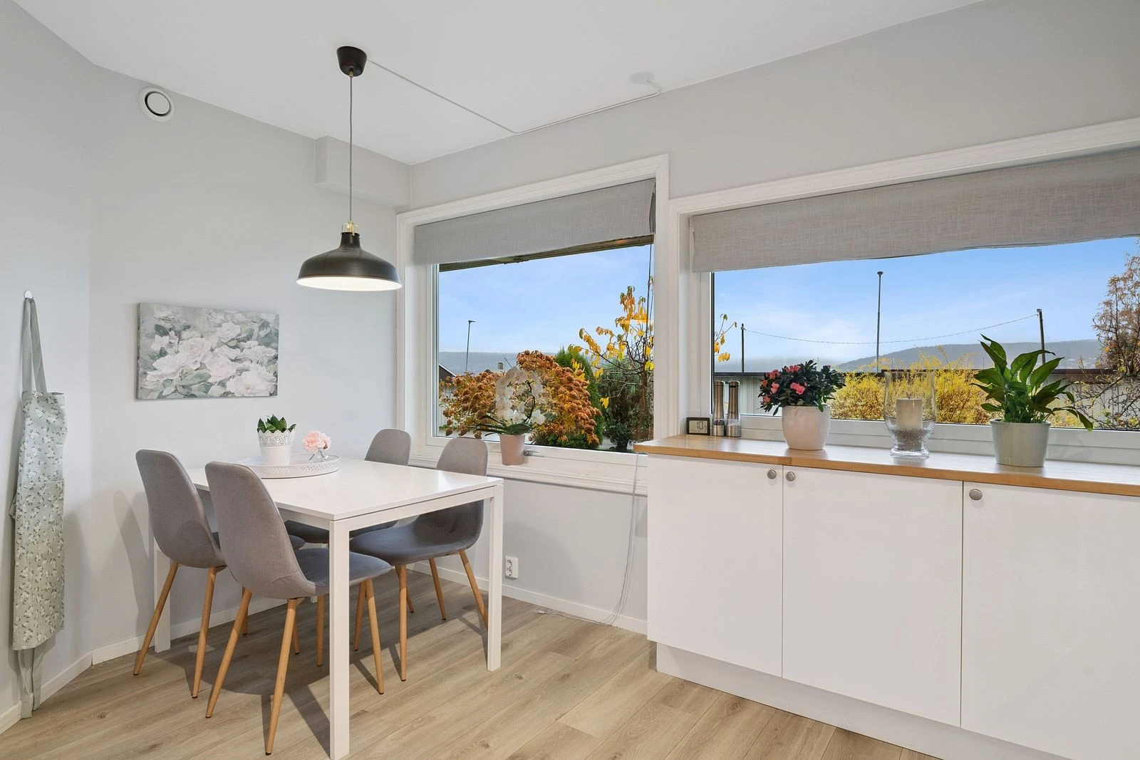 Lys og åpen kjøkkenløsning med plass til stort spisebord.