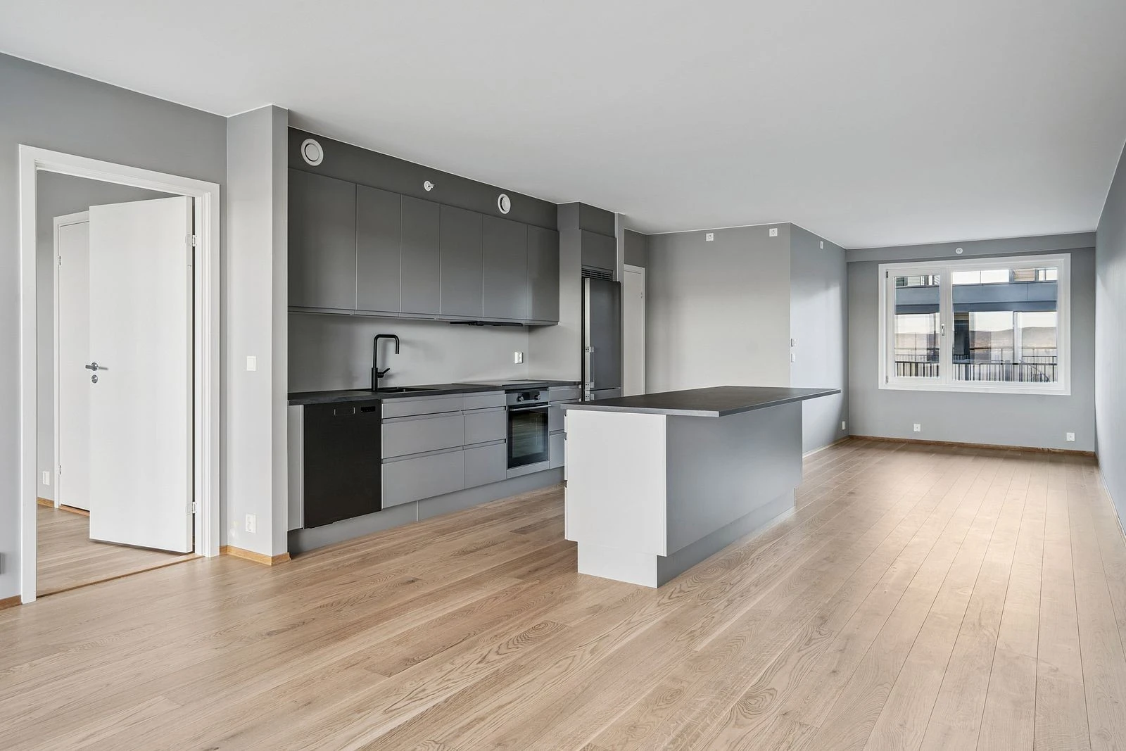 Gjennomtenkt planløsning med naturlig overgang mellom matlaging og avslapning.