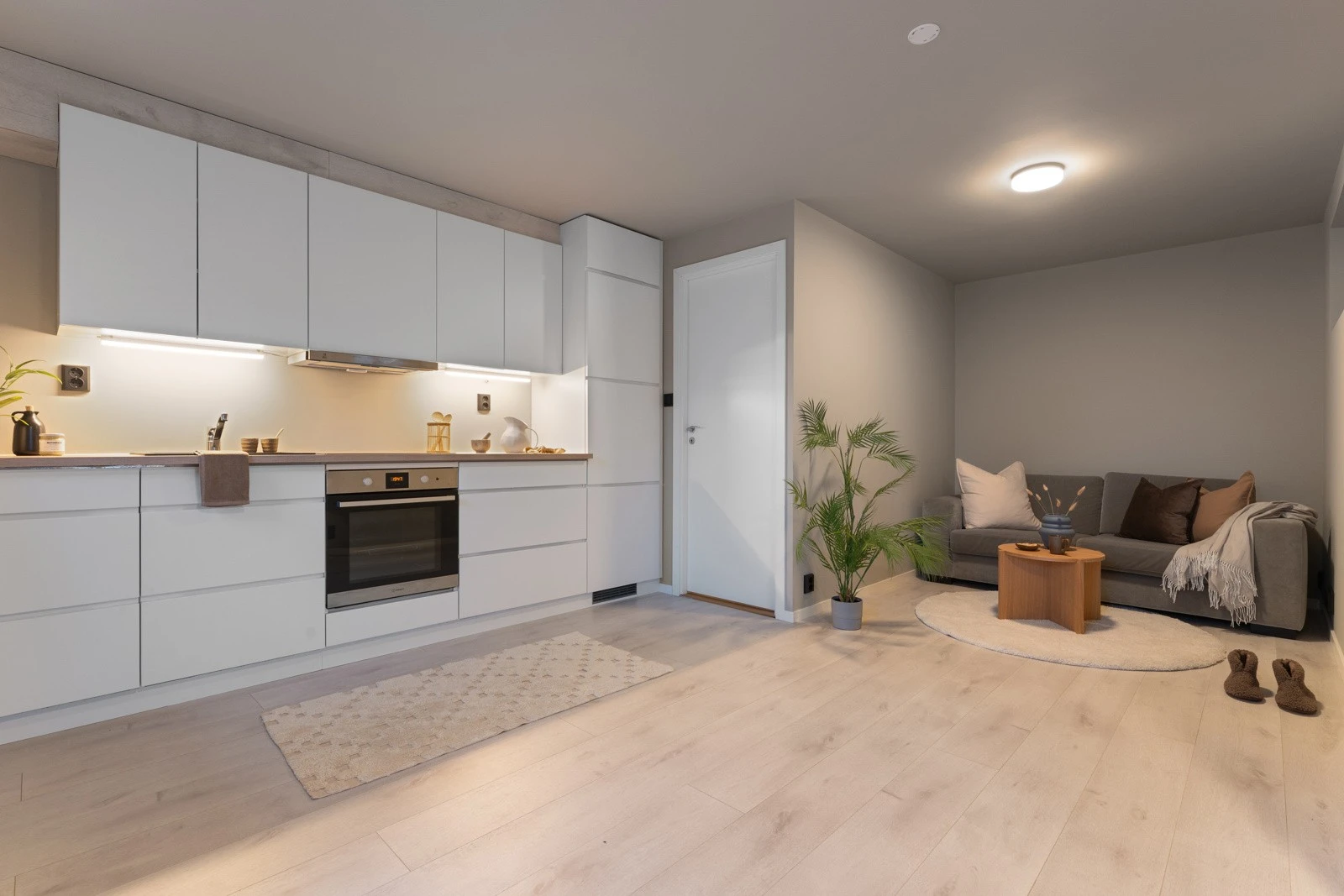 Kjøkkenet er innredet med tidløs og flott kjøkkeninnredning med glatte fronter og laminert benkeplate med kjøkkenvask. Galleribilde