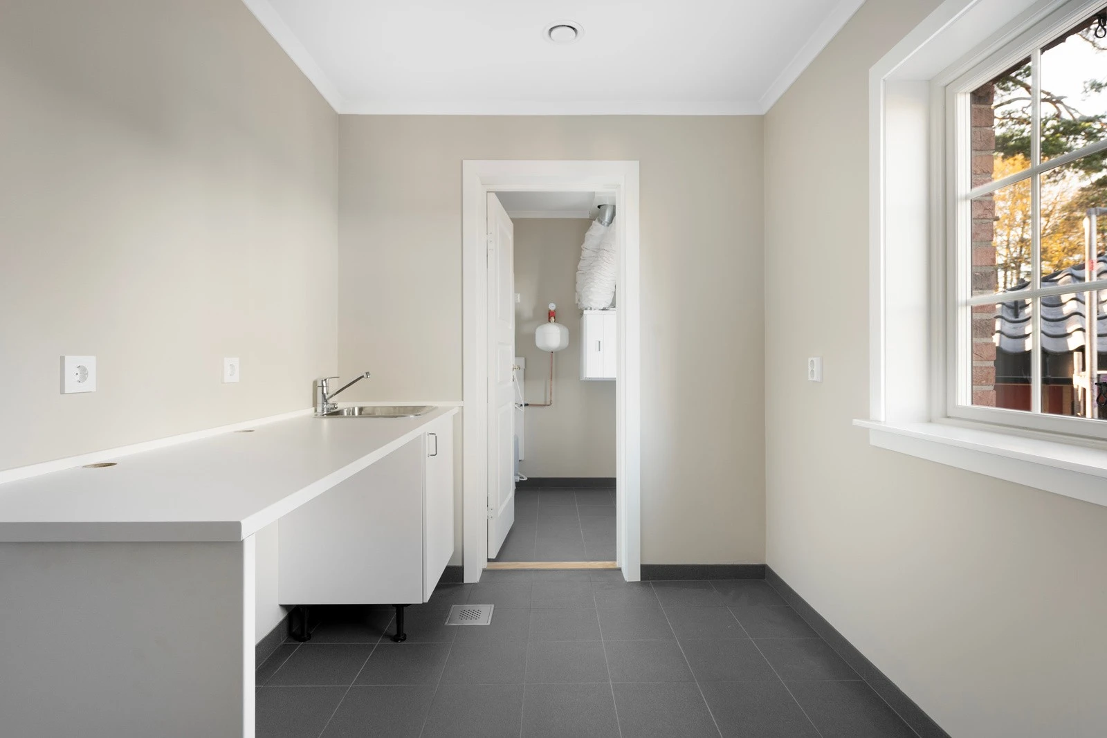 Vaskerommet har et praktisk design med teknisk rom innenfor, som gir deg enkel tilgang til nødvendige installasjoner og oppbevaring Galleribilde