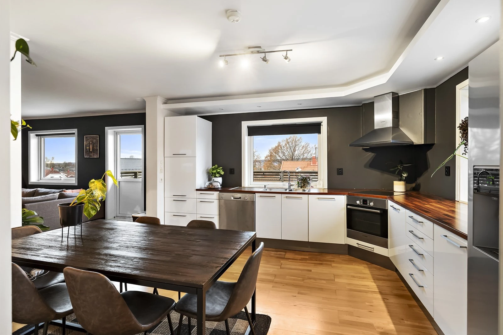 Kjøkkenet har hvite slette fronter og en trefarget benkeplate. Galleribilde