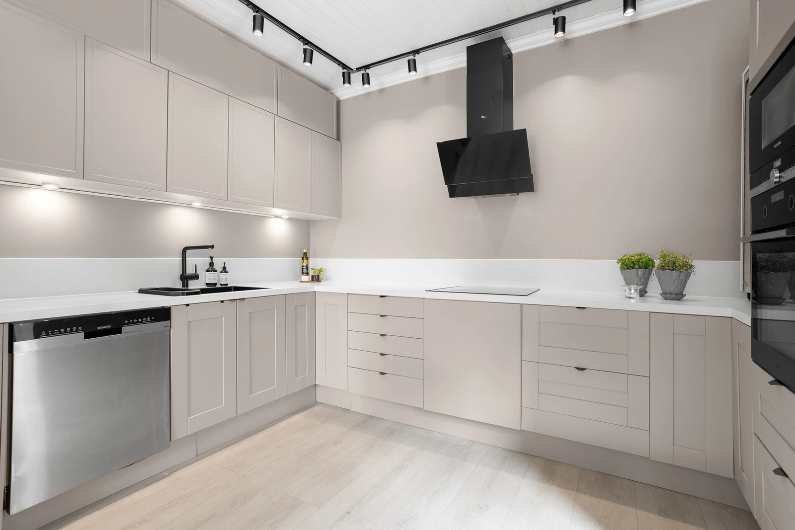 Kjøkkenet har delikat innredning med integrerte hvitevarer Galleribilde